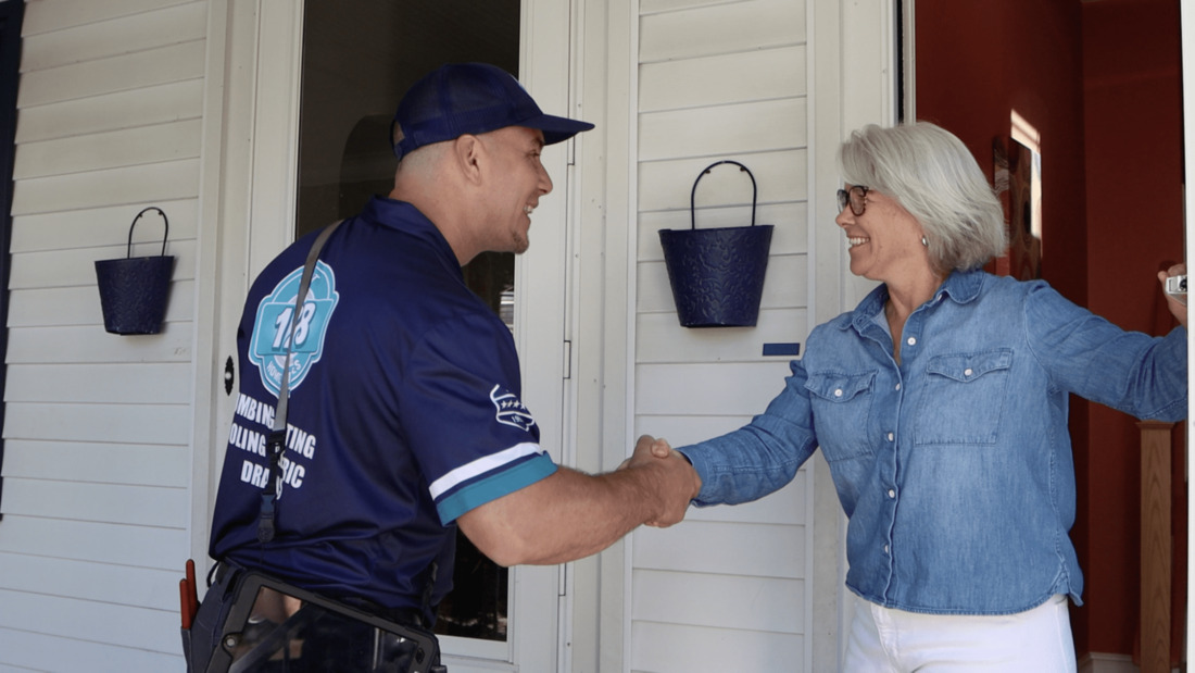 128 employee shaking hand of happy home owner after doing an air conditioning service in newton ma.